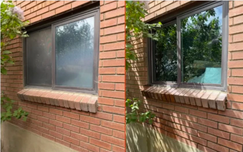 Before and after window cleaning on a brick home showing a cloudy pane restored to clear glass